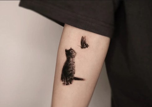 kitten and butterfly tattoo on the arm