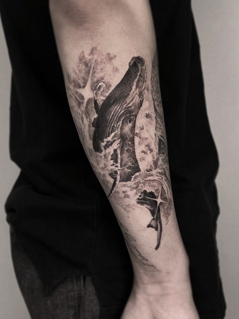 whale tattoo on the arm