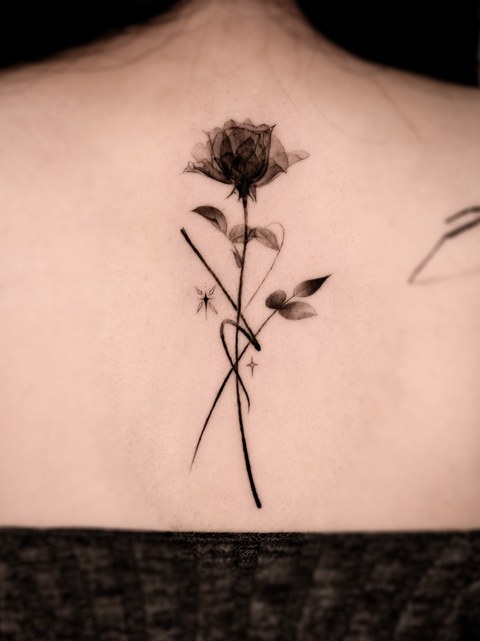 single flower tattoo on the back