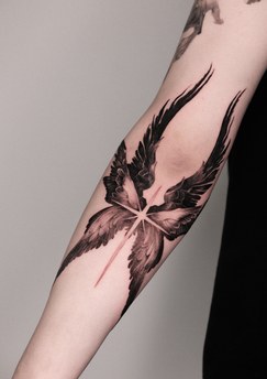 angel wing and star tattoo on the forearm