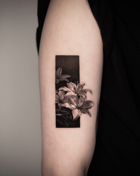 framed lily tattoo on the arm