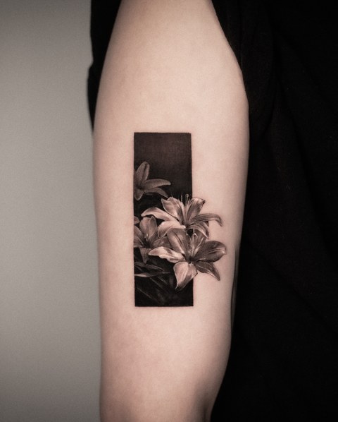 framed lily tattoo on the arm