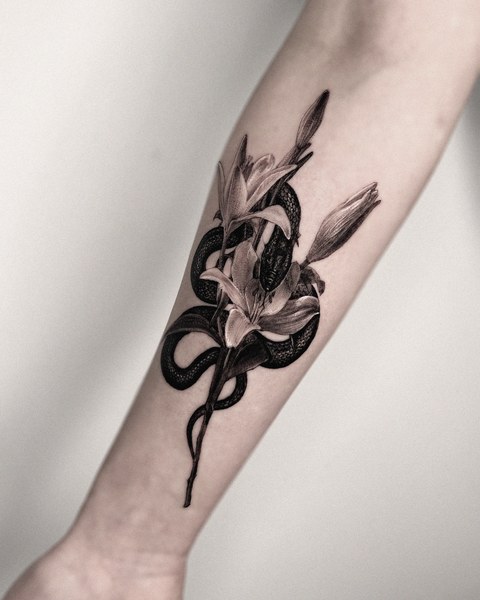 snake and flowers tattoo on the forearm
