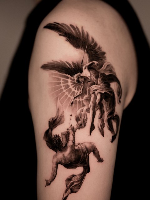 angel tattoo on the upper arm