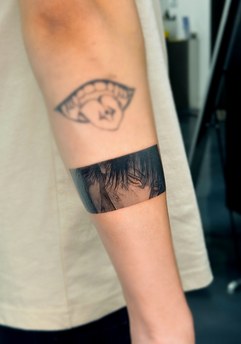 anime style eye tattoo on the arm