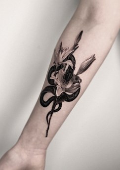 snake and flowers tattoo on the forearm