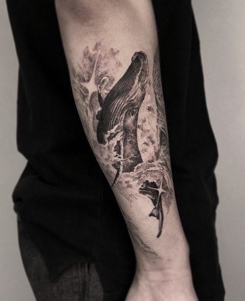 whale tattoo on the arm