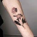 peony and leaves tattoo on the forearm