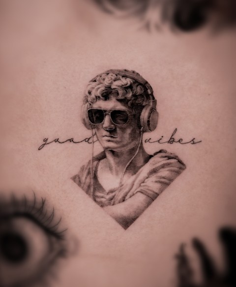 classical bust and script lettering tattoo on the arm
