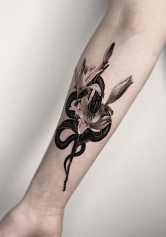 snake and flowers tattoo on the forearm