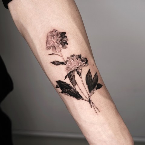 peony and leaves tattoo on the forearm