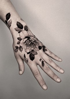 rose tattoo on the back of the hand