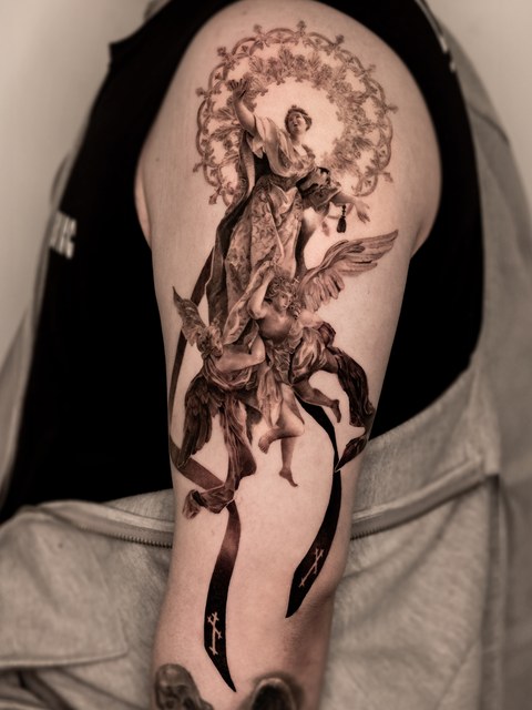 religious style tattoo from shoulder to arm