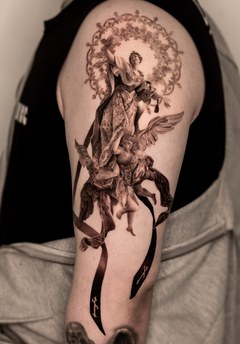 religious style tattoo from shoulder to arm
