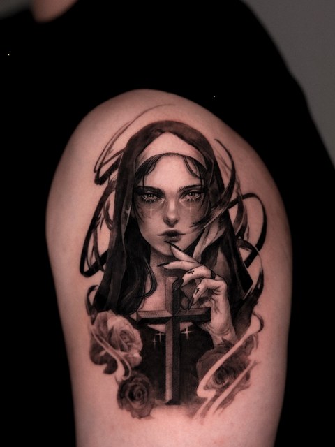 woman portrait tattoo on the upper arm