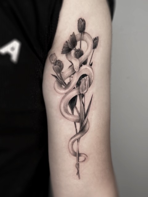snake and tulip tattoo on the forearm