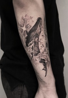 whale tattoo on the arm