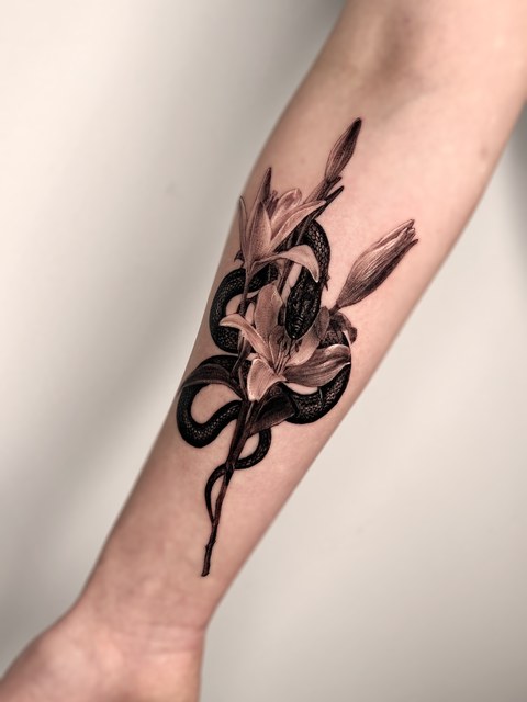 snake and flowers tattoo on the forearm